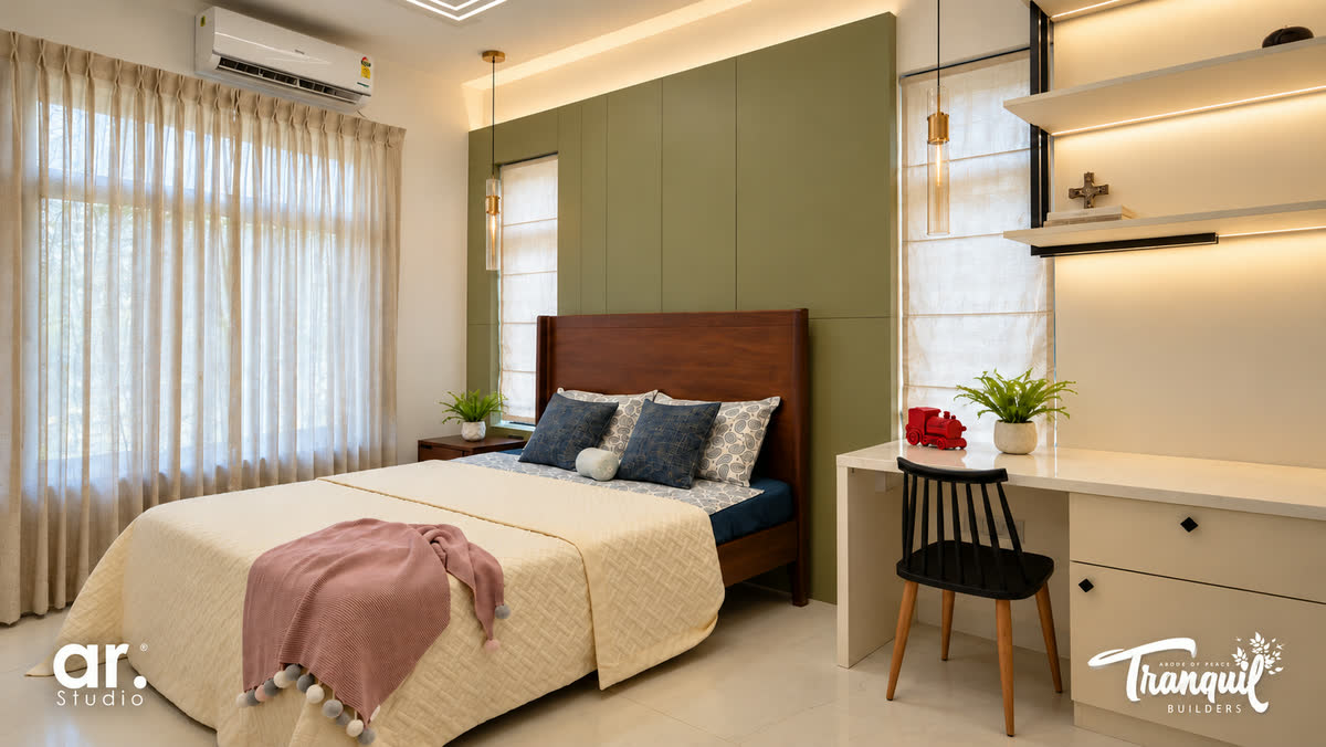 Ajish Residency — a bedroom with a study desk against the green panel