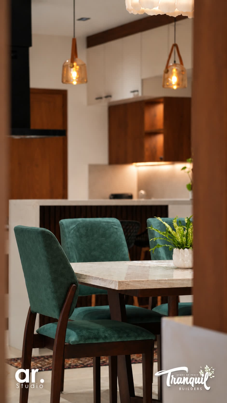 Ajish Residency — dining chairs with the kitchen beyond